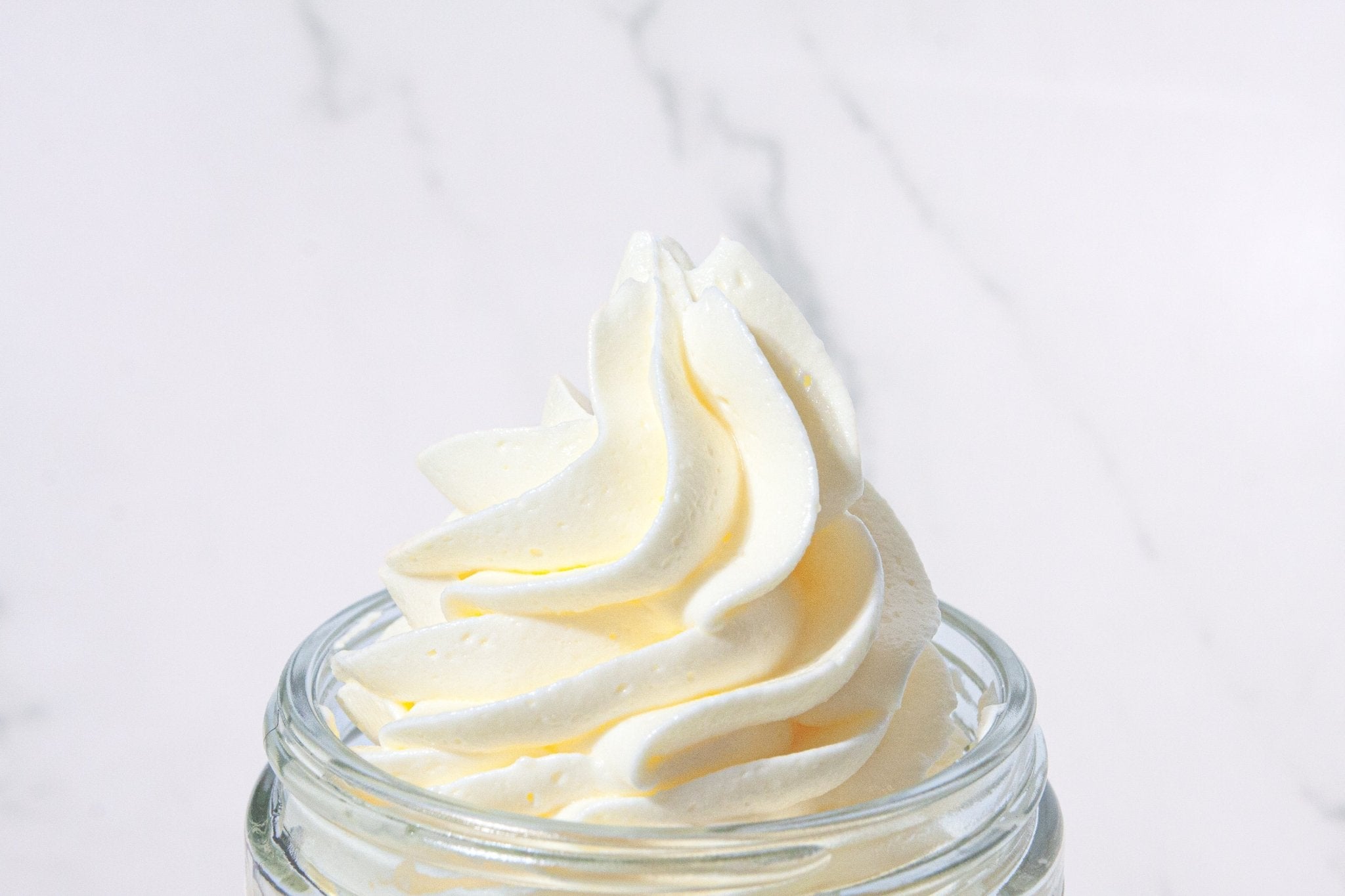 Luxurious handcrafted body butter with natural ingredients, featuring scents like Coconut, Pineapple Sage, and Amber Plum